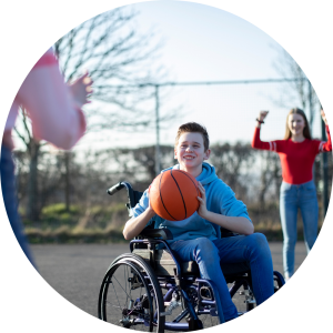 Boy in wheelchair playing basketball